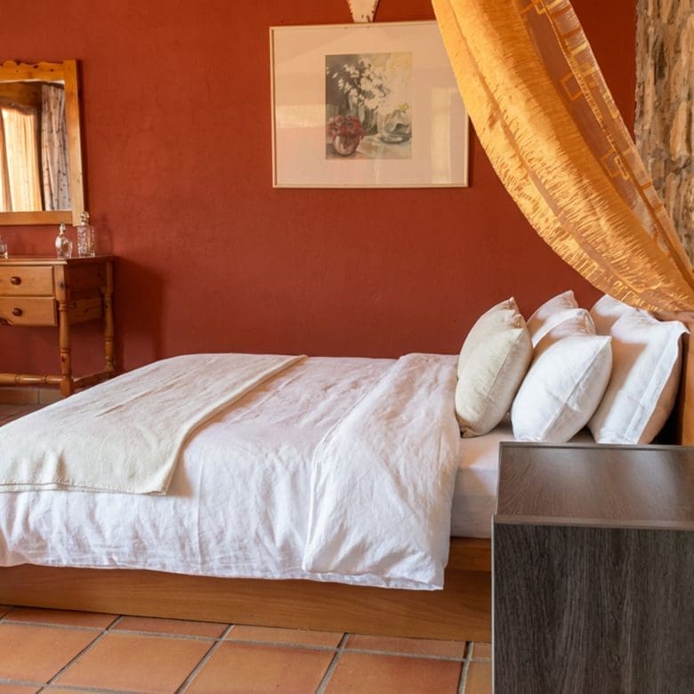 Lounge area with stone fireplace and bar counter in hotel property in Limi, Evia