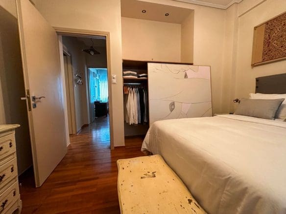 Bedroom view with parquet flooring and built-in wardrobe in Ampelokipoi renovated apartment