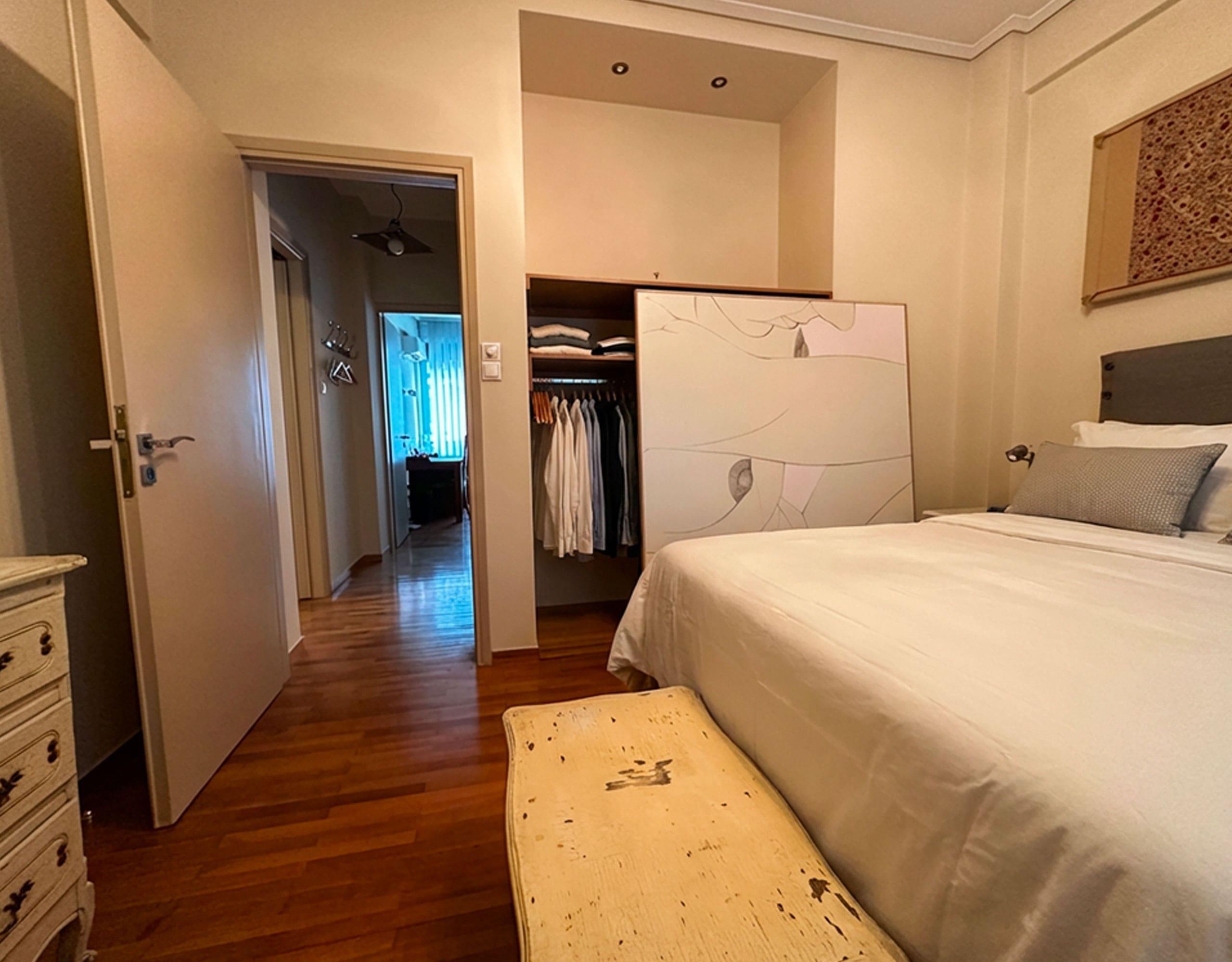 Bedroom view with parquet flooring and built-in wardrobe in Ampelokipoi renovated apartment