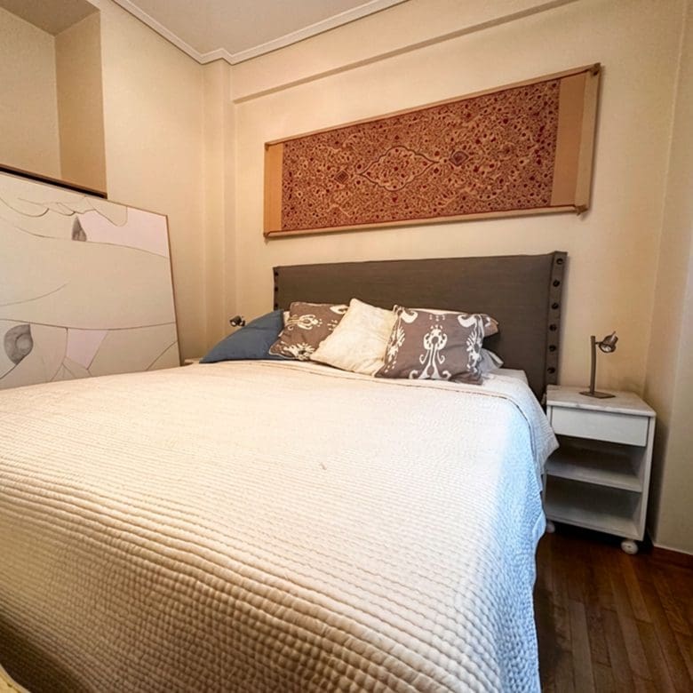 Main bedroom with double bed and bedside table in Ampelokipoi renovated apartment