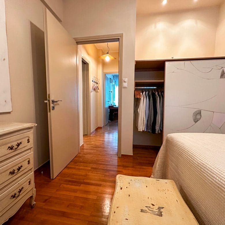 Bedroom with hallway view and built-in wardrobe in Ampelokipoi renovated apartment