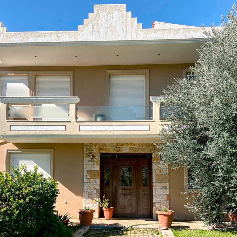 Exterior façade and front entrance of the detached maisonette in Eretria, Evia