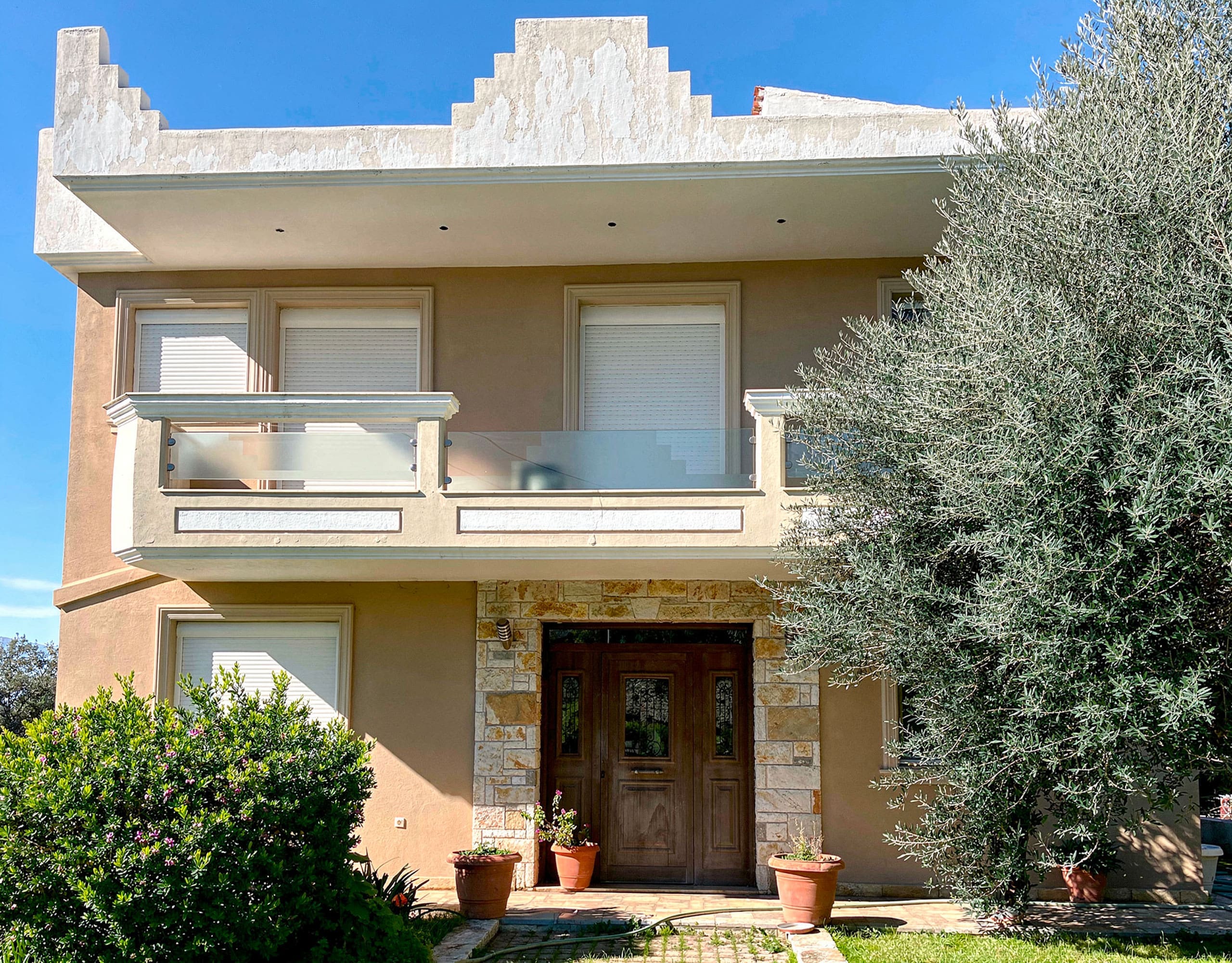 Exterior façade and front entrance of the detached maisonette in Eretria, Evia