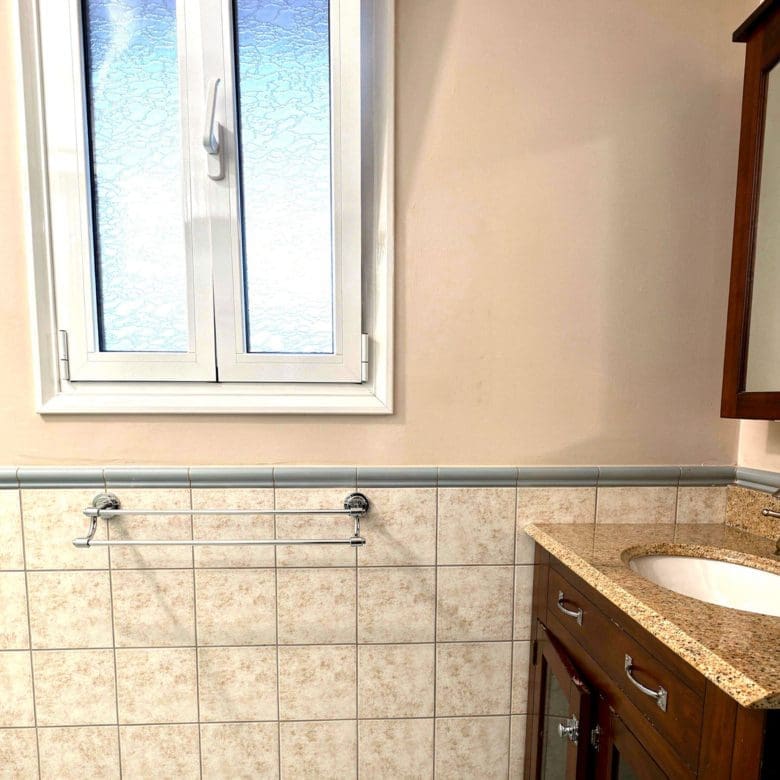 Bathroom window and tiled wall detail in the Eretria maisonette