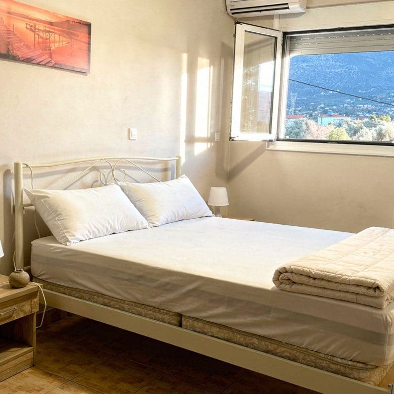 Bedroom with window sea view in the Eretria maisonette, Evia