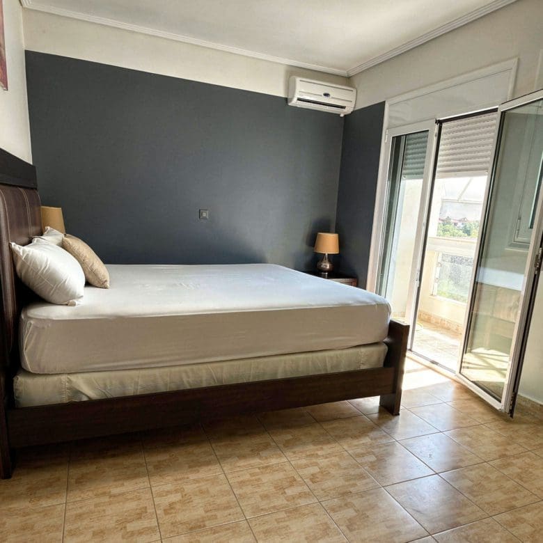 Bedroom with double bed and natural light in the detached maisonette in Eretria