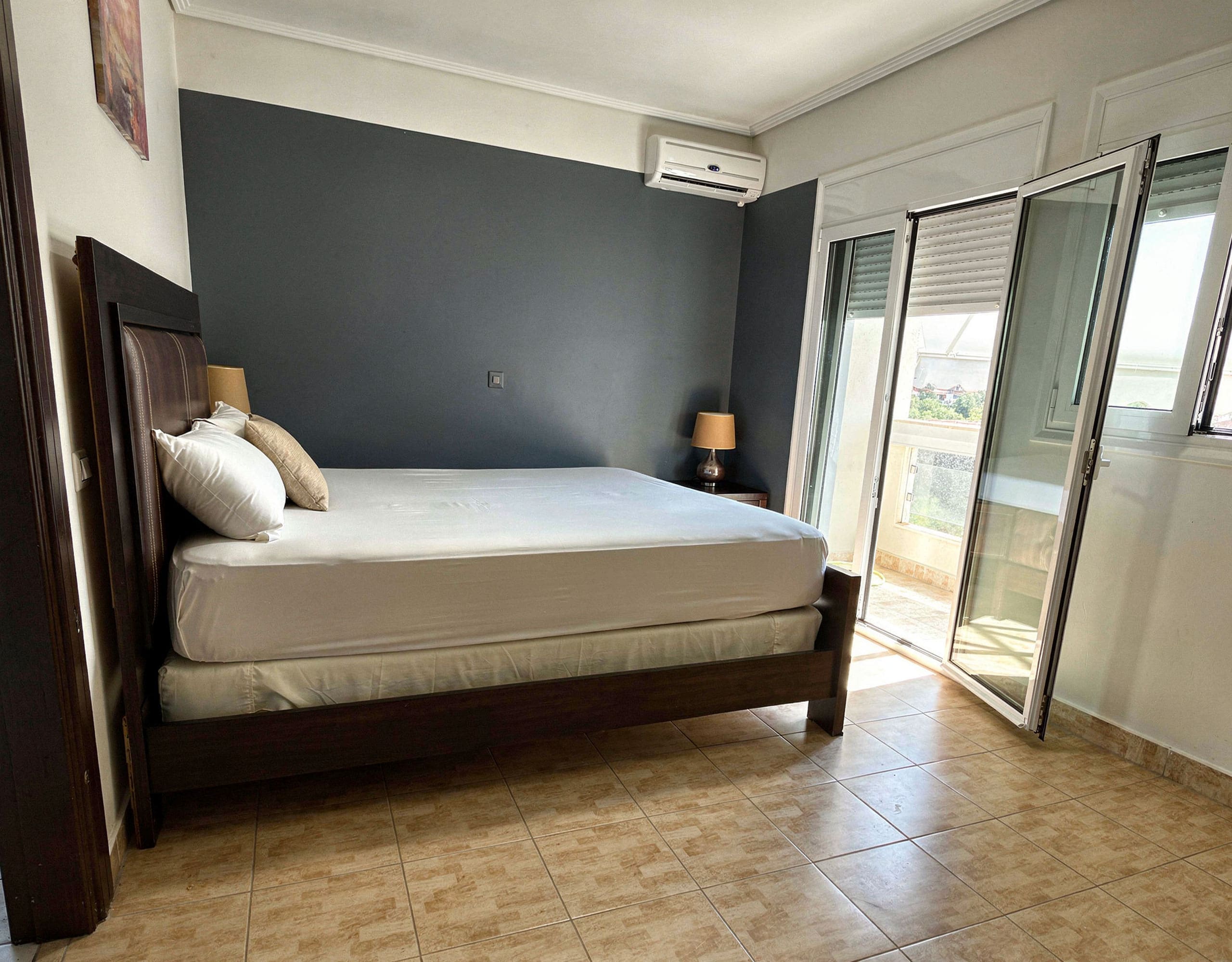 Bedroom with double bed and natural light in the detached maisonette in Eretria