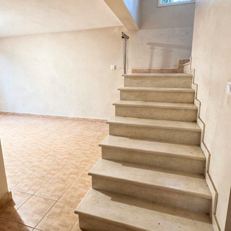 Interior staircase connecting levels in the three-level maisonette in Eretria Title: Interior Staircase — Three-Level Maisonette