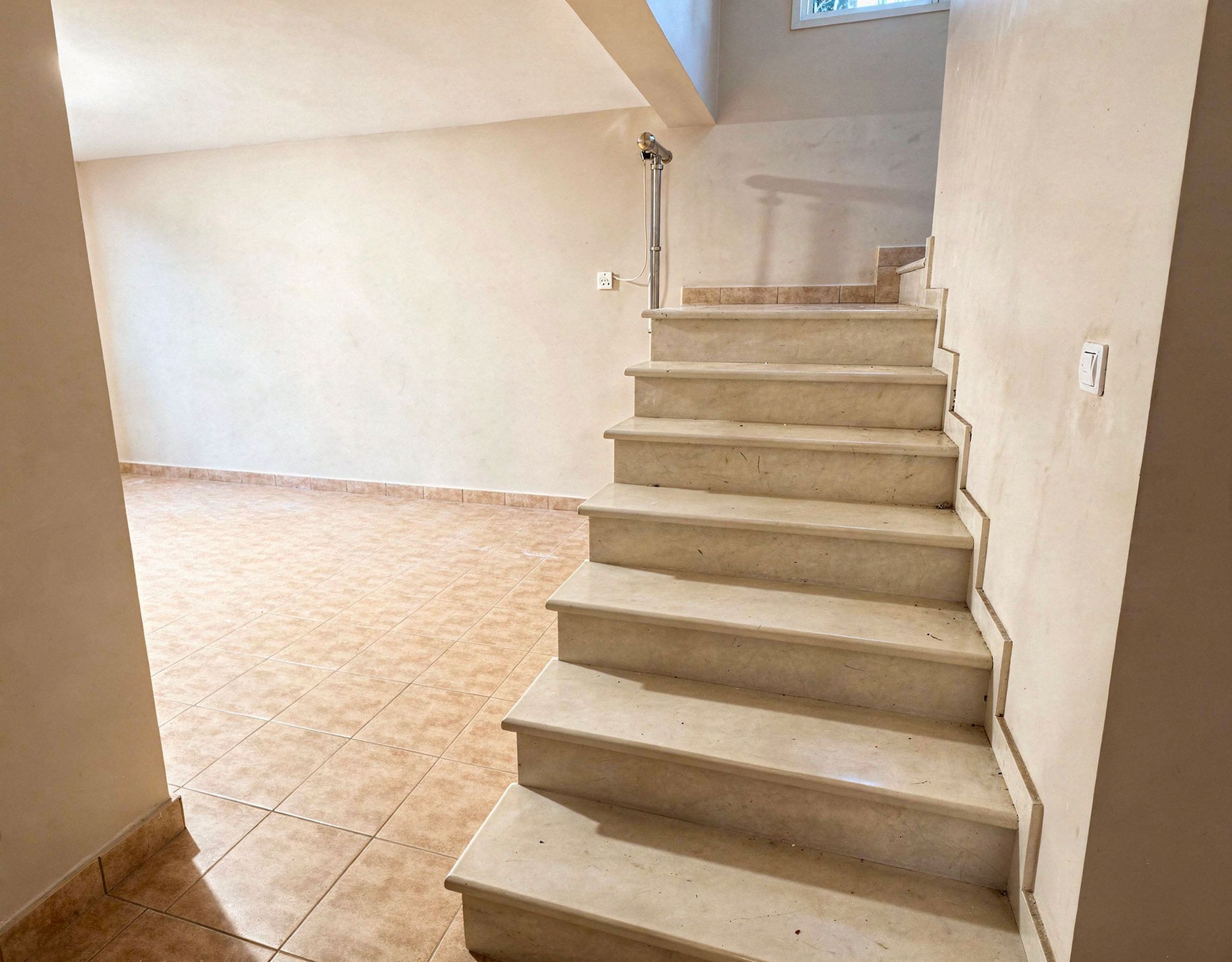 Interior staircase connecting levels in the three-level maisonette in Eretria Title: Interior Staircase — Three-Level Maisonette