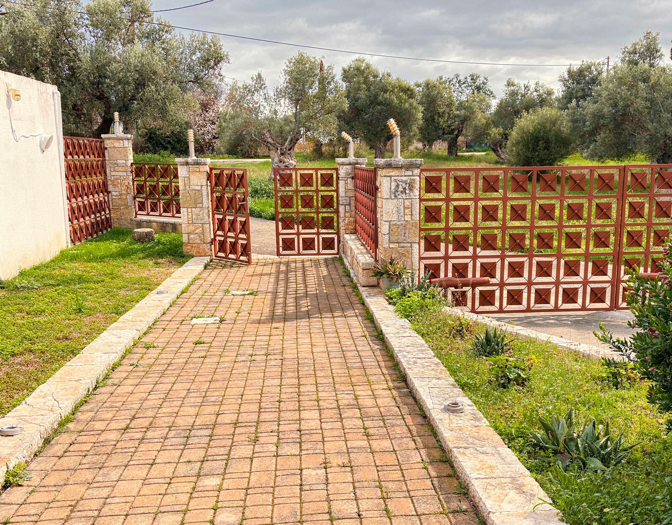 Driveway entrance path leading to the detached maisonette in Eretria, Evia