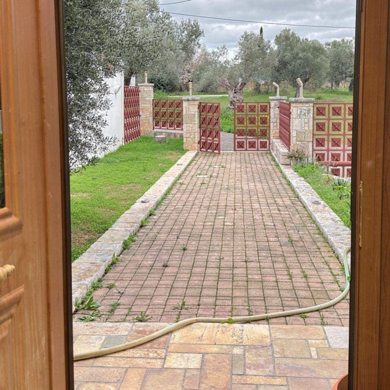 View of the driveway and entrance path from inside the maisonette in Eretria