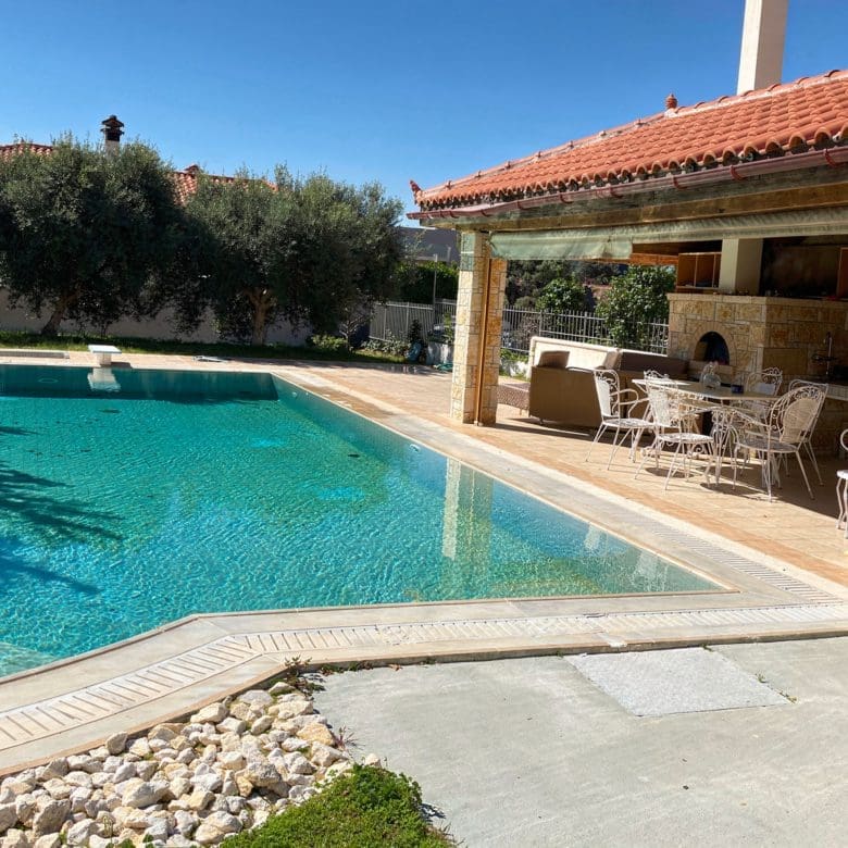 Private pool with covered BBQ area and outdoor kitchen at the maisonette in Eretria