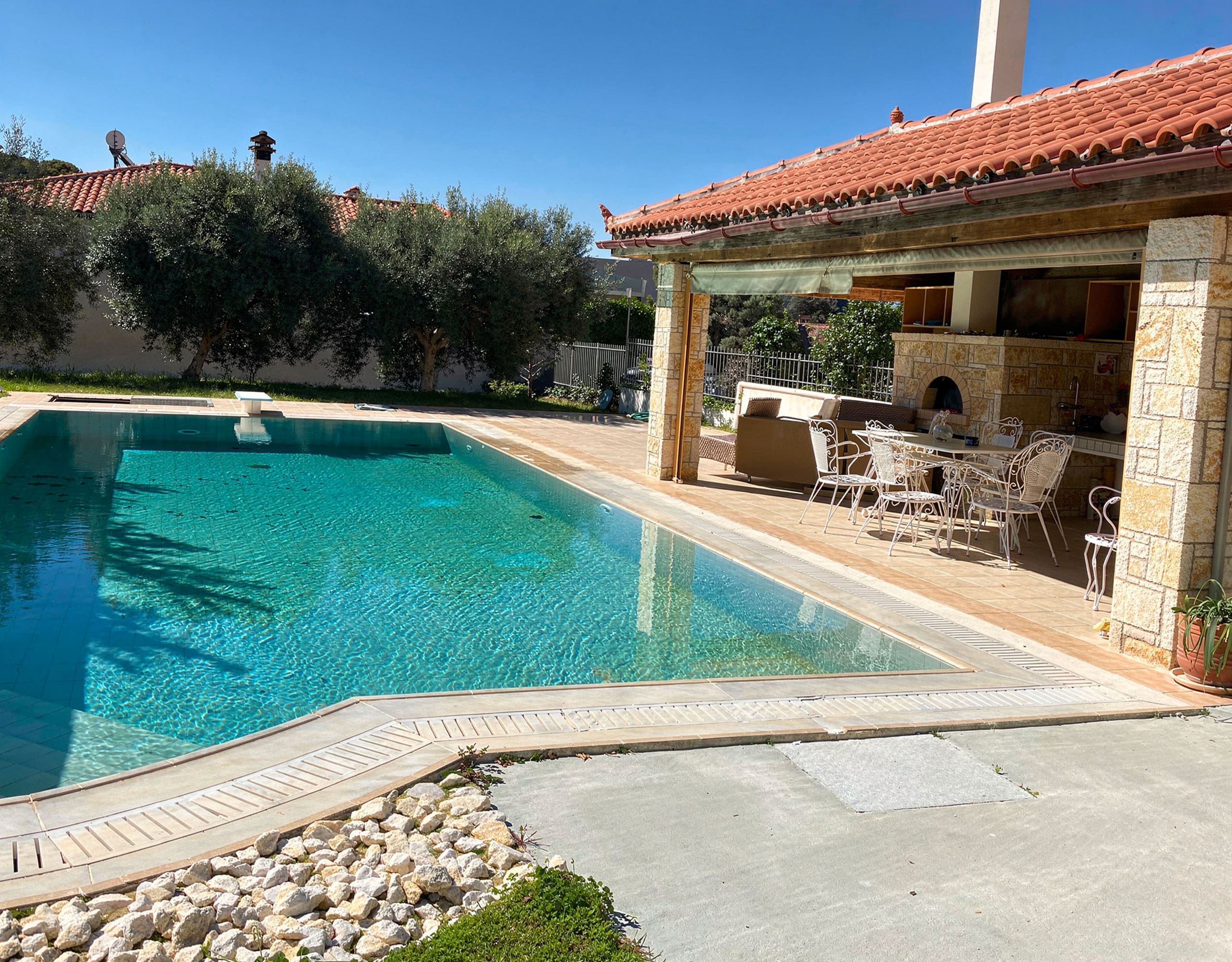 Private pool with covered BBQ area and outdoor kitchen at the maisonette in Eretria