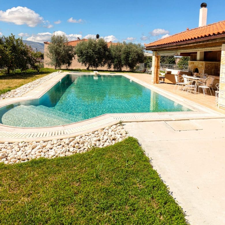 Shaded outdoor seating next to the private pool at the Eretria maisonette