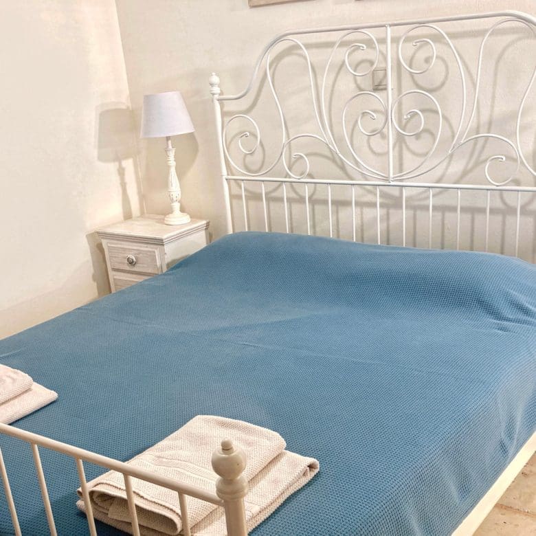 Bedroom with blue bedding in Kea (Tzia) luxury maisonette